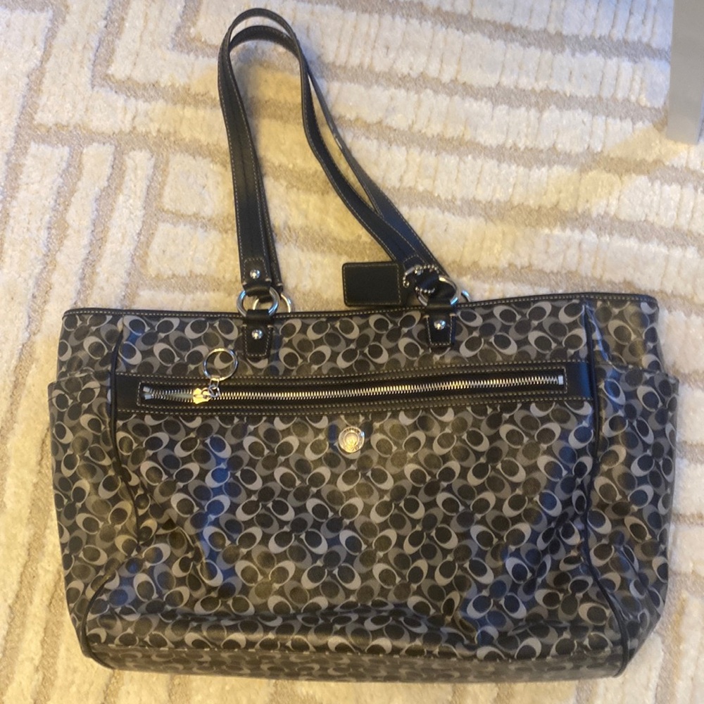Coach bag that can also be a diaper bag as it comes with a pad.